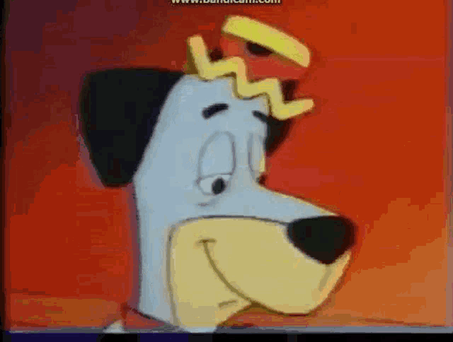 a cartoon dog with a crown on his head is smiling .