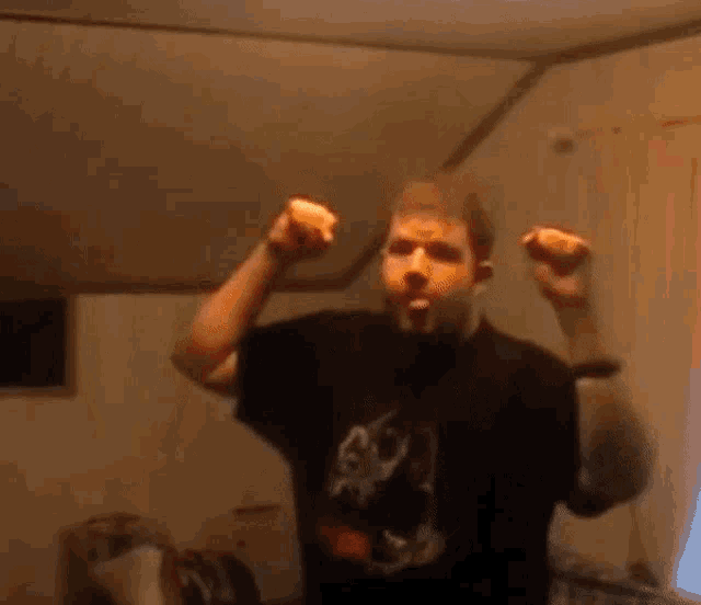 a man in a black shirt with a picture of a wolf on it