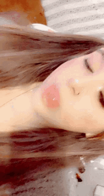 a close up of a woman 's face with a red spot on her cheek