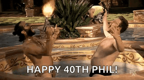two naked men are sitting in a hot tub holding a torch and shouting happy 40th phil .
