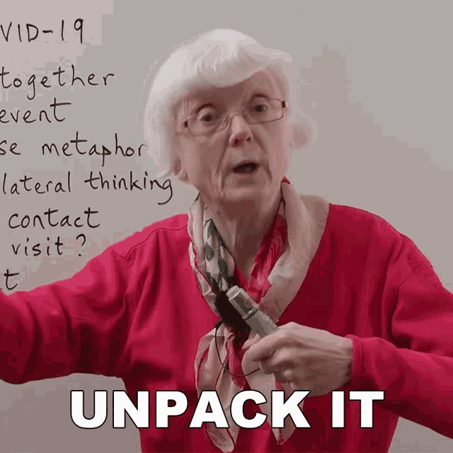 an elderly woman holds a pen in front of a whiteboard that says ' unpack it '