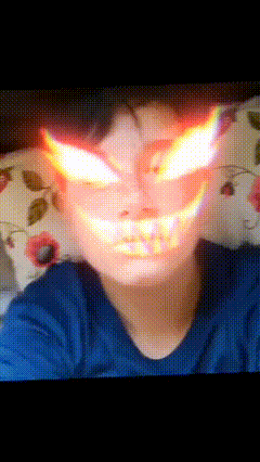 a blurry picture of a person 's face with flames coming out of it 's eyes