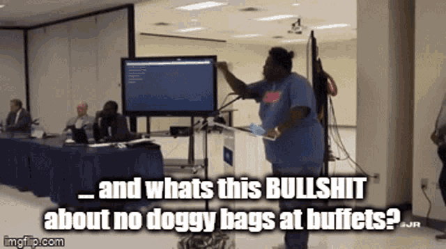 a woman stands in front of a podium and says " and whats this bullshit about no doggy bags at buffets