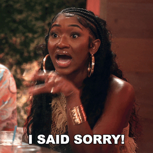 a woman with a surprised look on her face is saying i said sorry