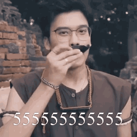 a man wearing glasses and a mustache is holding a harmonica .