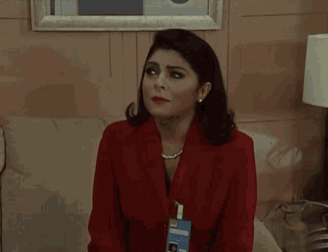 a woman in a red jacket is covering her mouth