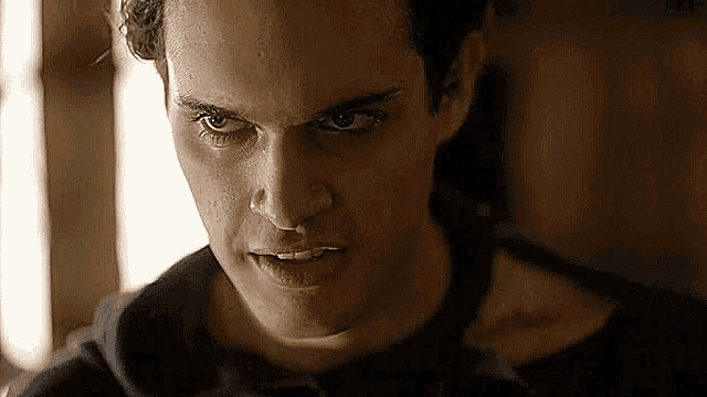 a close up of a man 's face with a very angry expression .
