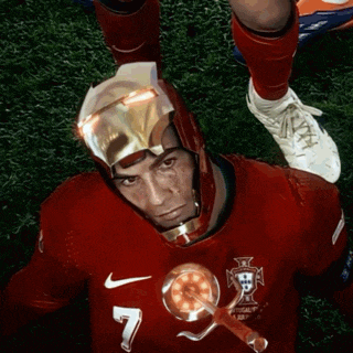 a man wearing an iron man helmet is laying on the grass