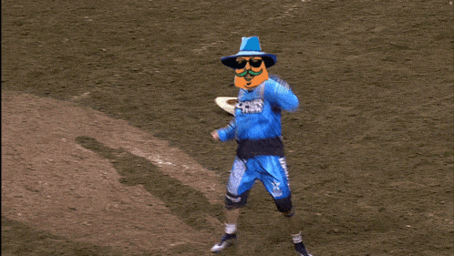 a man wearing a doper tires shirt stands in a dirt field