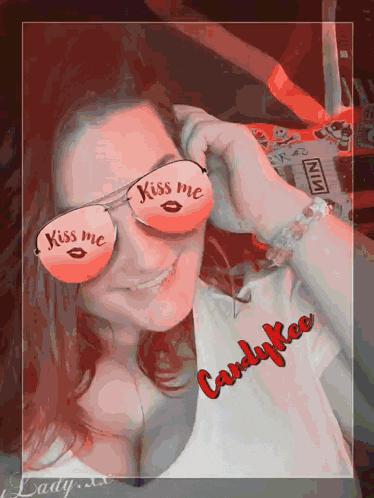 a woman wearing sunglasses that say " kiss me "