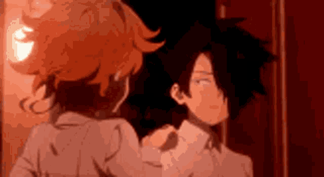 a man and a woman are standing next to each other in a dark room .