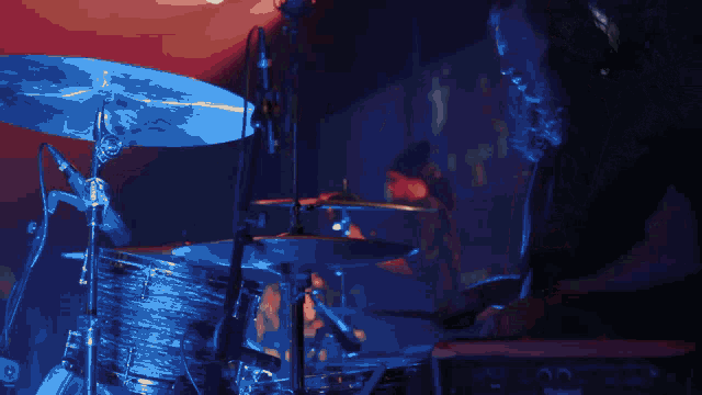 a man playing drums in front of a microphone that says ' yamaha ' on it