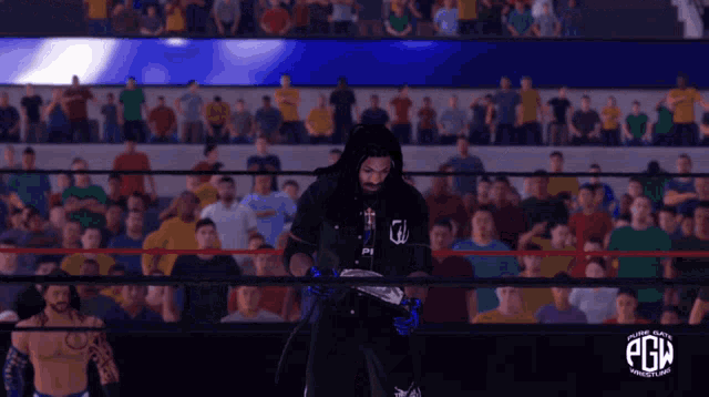 a man in a wrestling ring with the word pgm on the bottom