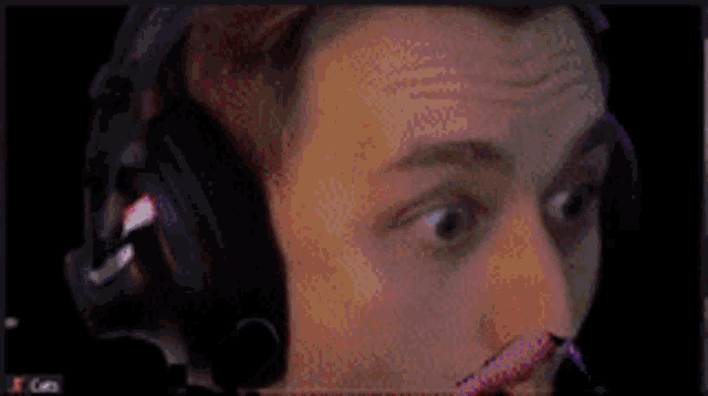 a man wearing headphones looks surprised in a blurry photo