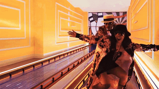 a man and a woman are standing on a roller coaster