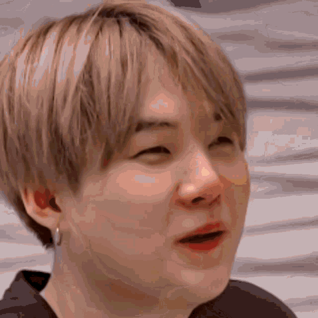 a close up of a person 's face making a funny face with their mouth open .