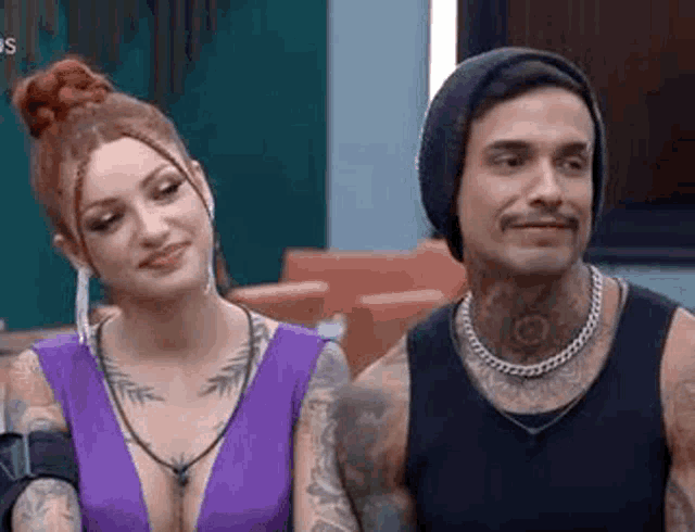 a man and a woman are sitting next to each other in a living room .