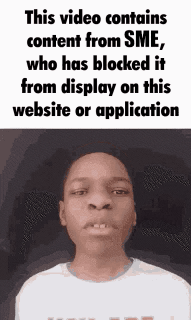 a young boy stands in front of a sign that says this video contains content from sme who has blocked it