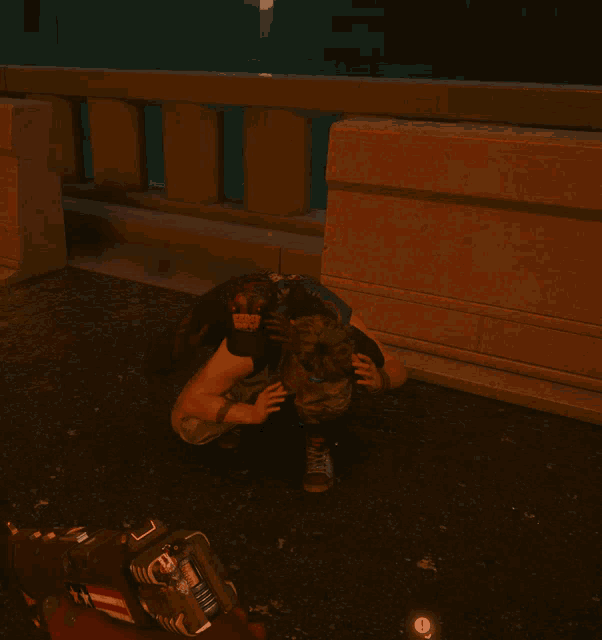 a man with a tattoo on his arm is kneeling down on the ground in front of a railing