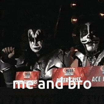 peter criss and gene simmons are standing behind a table