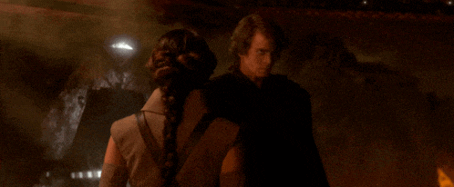 a man and a woman are standing next to each other in a dark cave