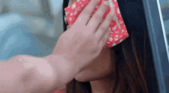 a woman wearing a red headband is being touched by a man