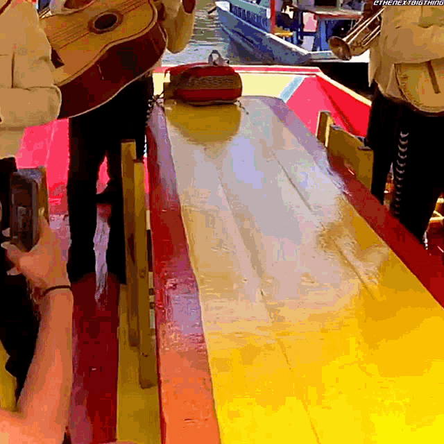 a man playing a guitar and a man playing a banjo on a boat with the words " there is nothing " visible