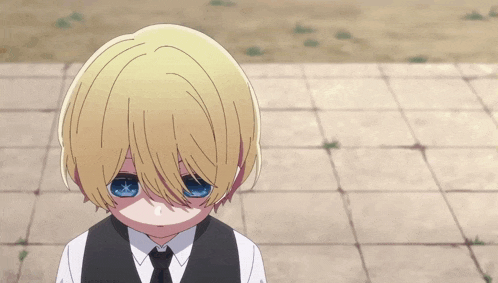 a young boy with blonde hair and blue eyes is wearing a white shirt and black vest