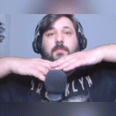 a man with a beard wearing headphones and a brooklyn shirt