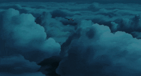 a plane flying through a cloudy sky with a blue sky in the background