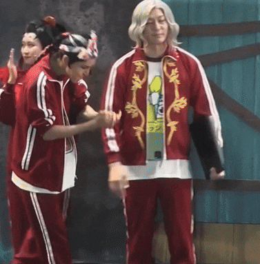 a man in a red jacket has a t-shirt on that says ' tokyo ' on it