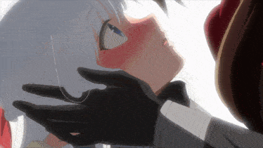a close up of a person touching a girl 's face with their hand