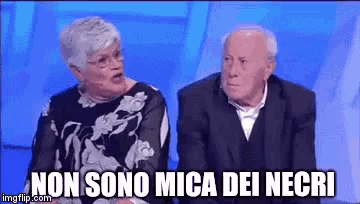 a man and a woman are sitting next to each other and the man is saying non sono mica dei necri