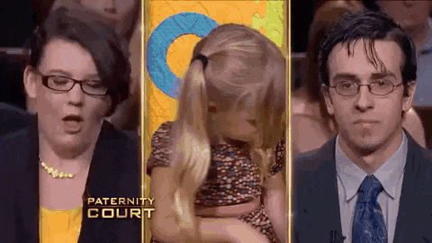 a man and a woman are sitting in front of a picture of a little girl on a paternity court show .