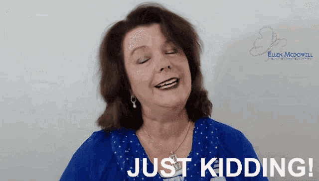 a woman says just kidding in front of a white board