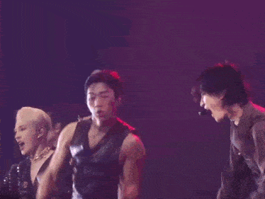 a group of people are dancing on a stage and one of them is laughing