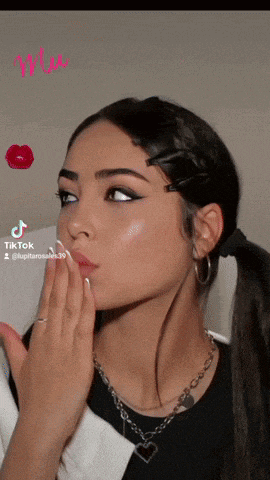 a woman blowing a kiss with a tiktok watermark on the bottom