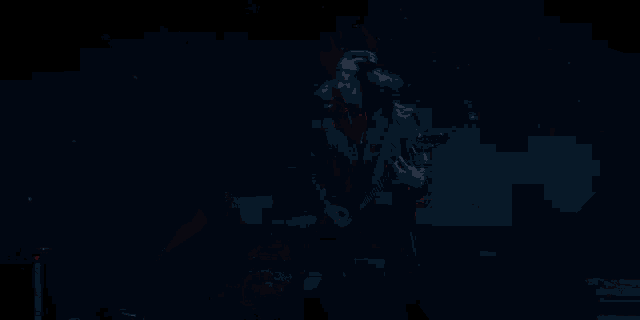 a man in a hooded jacket is standing in a dark room with a red light behind him .