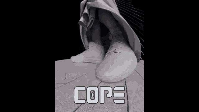 a statue of a man with a beard holding a basketball with the word cope below him