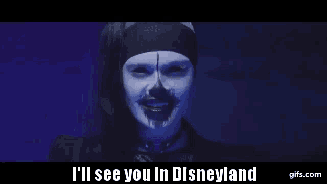 a woman with blue face paint and the words i 'll see you in disneyland on the bottom