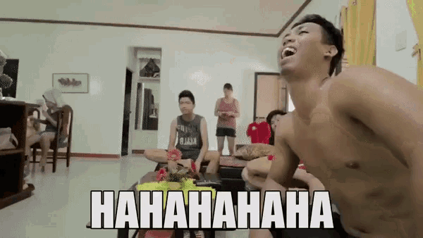 a shirtless man is laughing in a living room with the words " hahahaha " written on the bottom