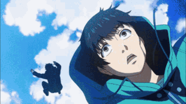 a man in a blue jacket looks up at the sky