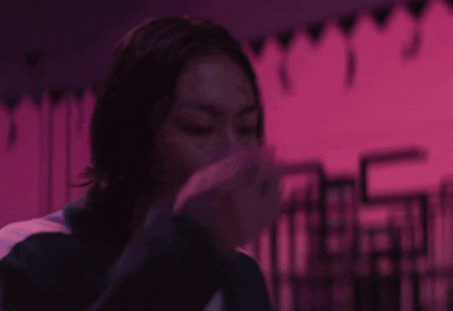 a person with blood on their shirt is covering their face