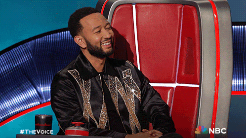 a man is sitting in a chair with a nbc logo on the bottom