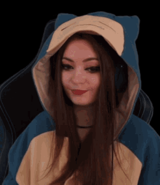 a woman is wearing a hoodie that looks like a cartoon character