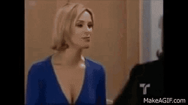 two women are fighting in a living room .