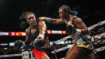 two female boxers are fighting in a ring with everlast gloves