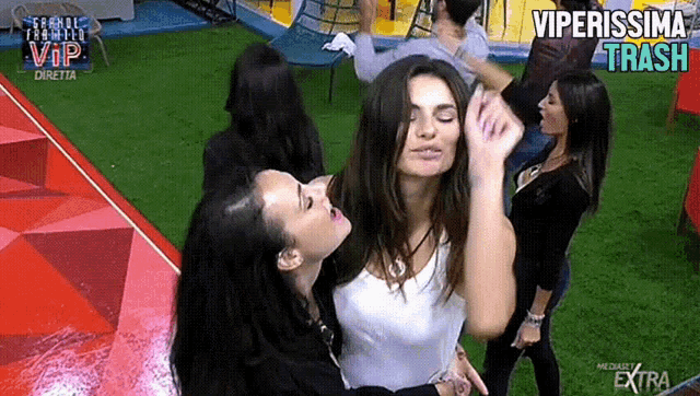 a group of women are dancing in front of a screen that says vip diretta