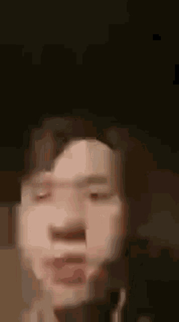 a close up of a man 's face with a blurry background .