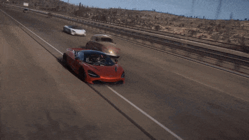 an aerial view of a red sports car with a person driving it